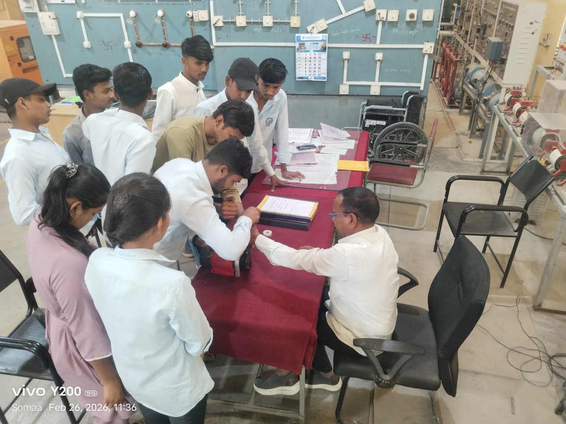 Electrician trainees at the control panel training board